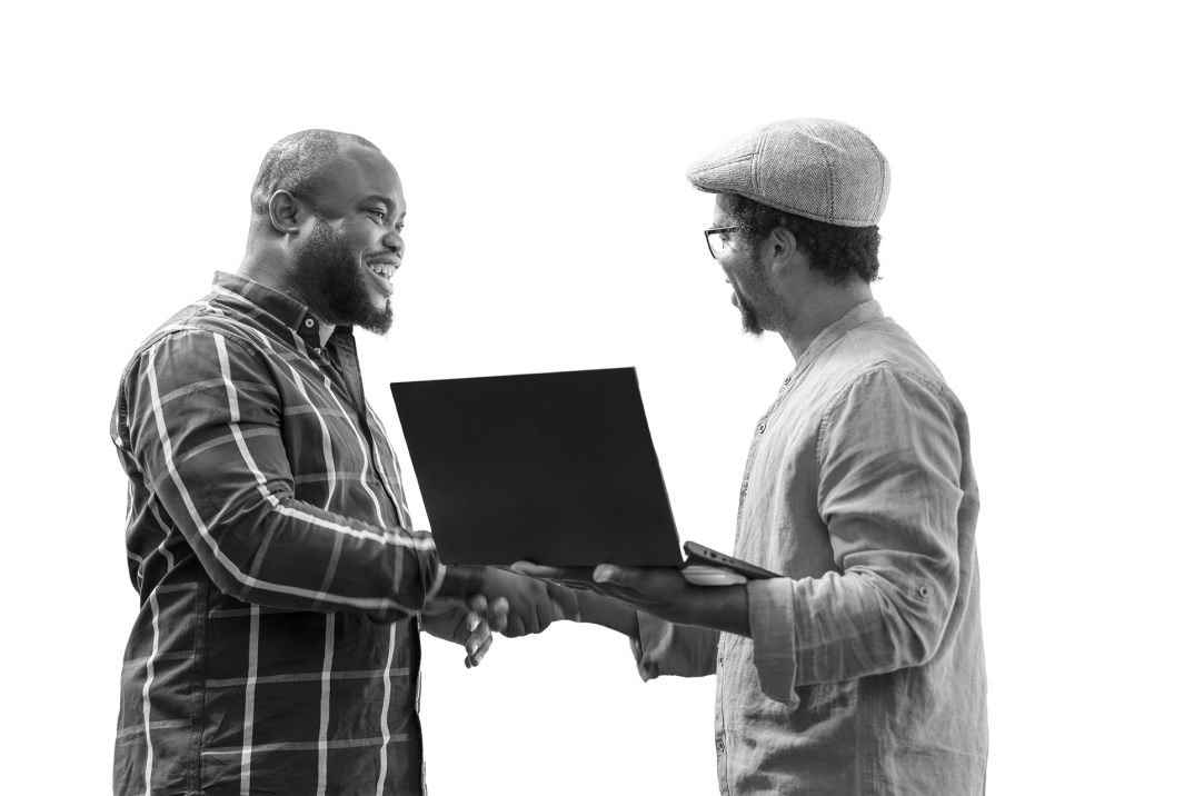 Two men shaking hands while one of them holds a laptop
