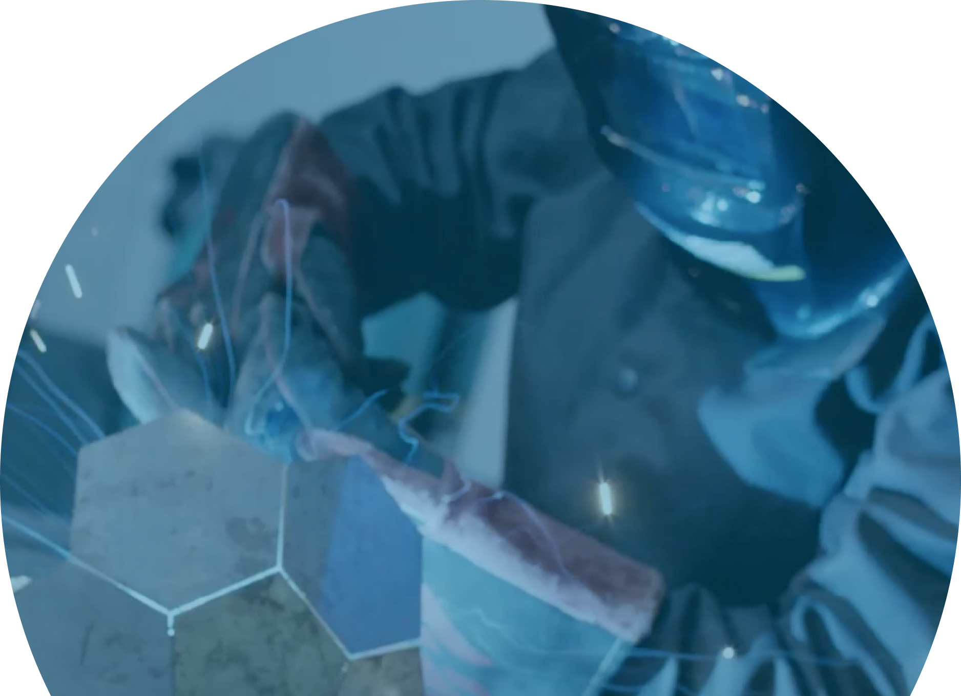 a person in a welding mask wearing protective gloves
