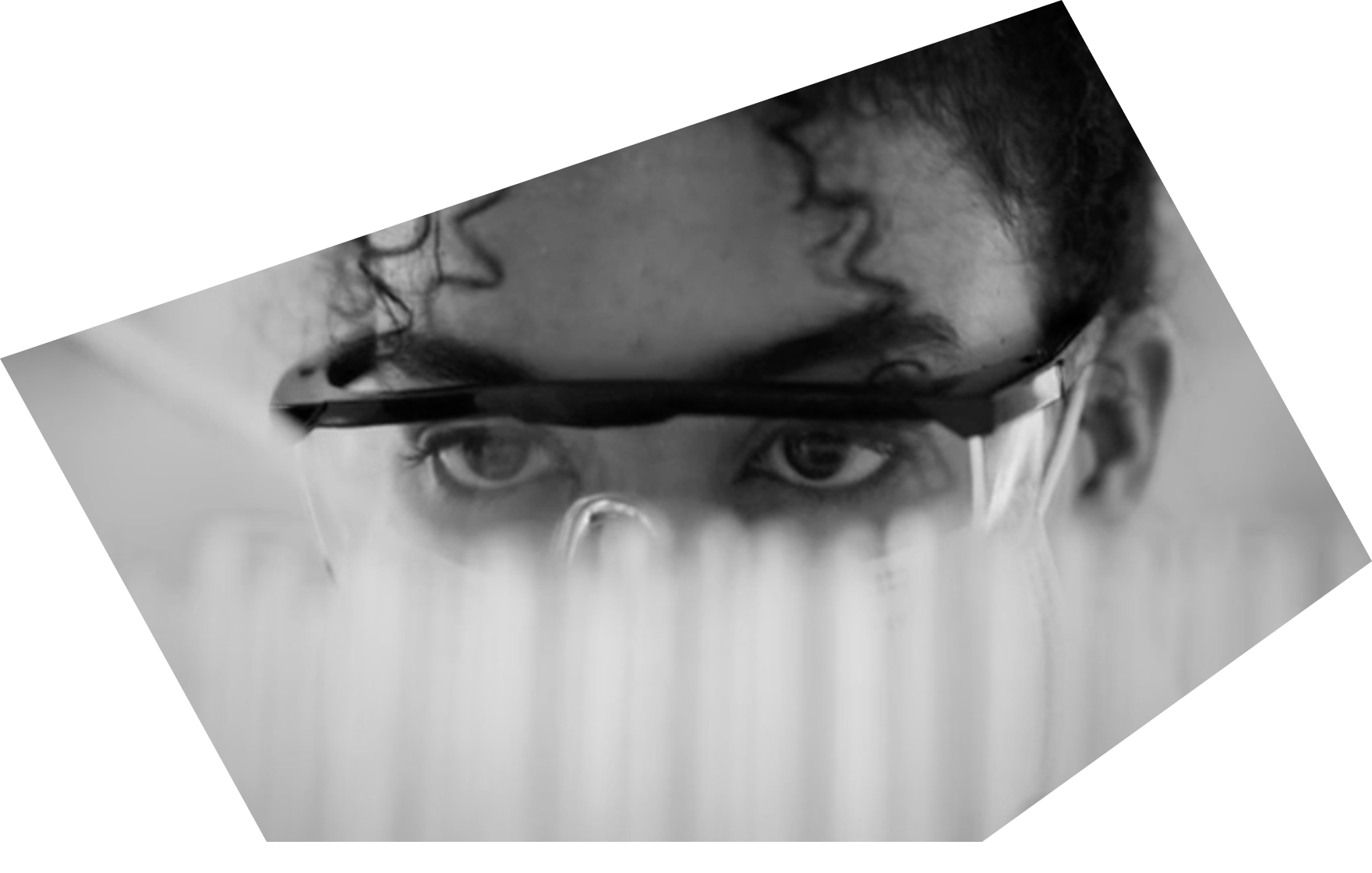 Top part of the face of a female researcher or clinician wearing clear protective glasses