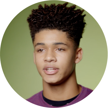 black young man in purple tshirt performing poetry
