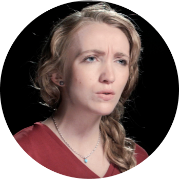 young white woman with a side ponytail wearing a red v-neck shirt