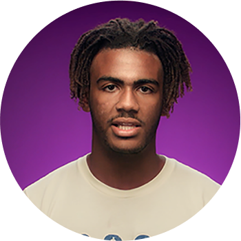 young black man in cream t-shirt performing poetry