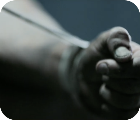 a man with dark skin's hand is out of focus