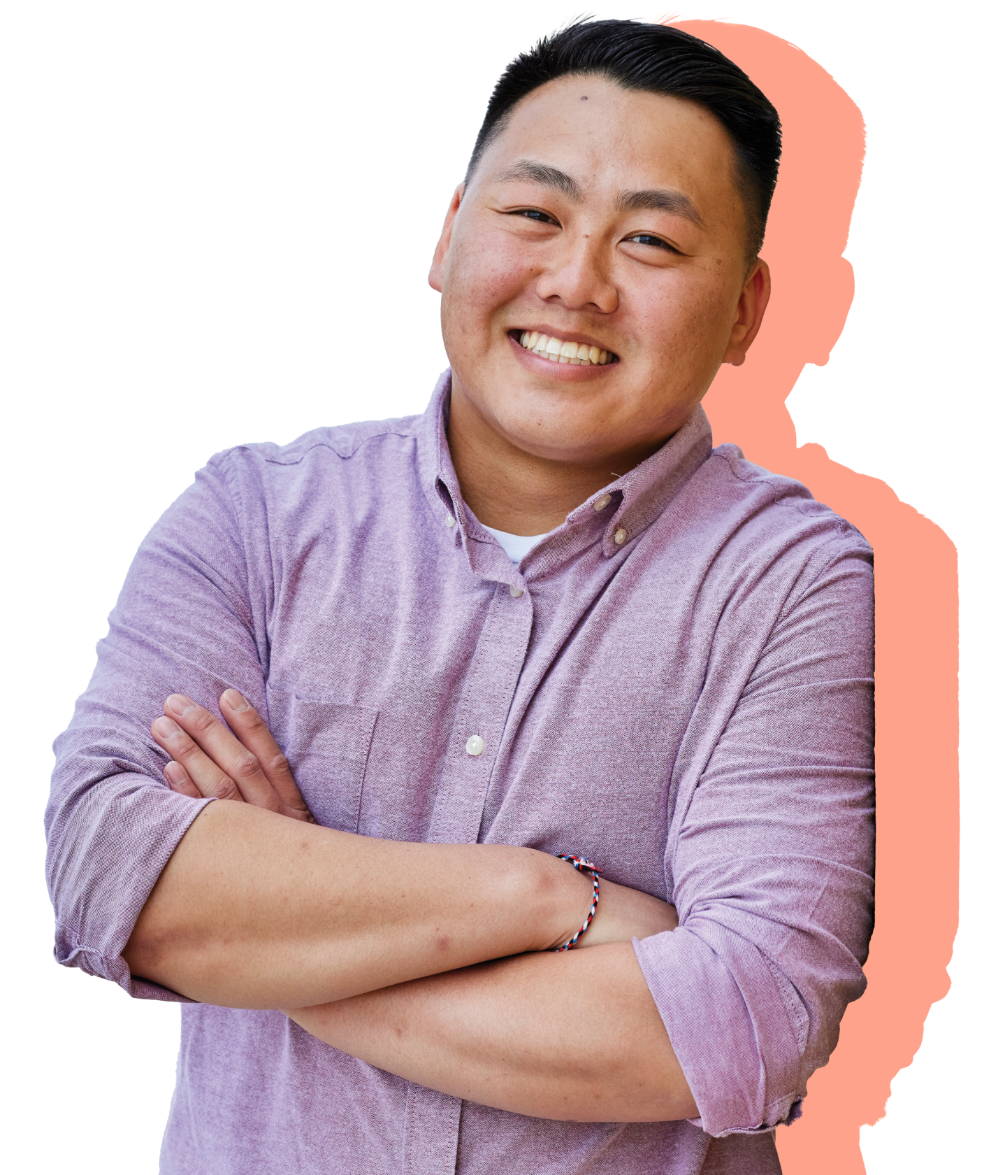 An asian man with folded arms smiling and leaning up against a design research document