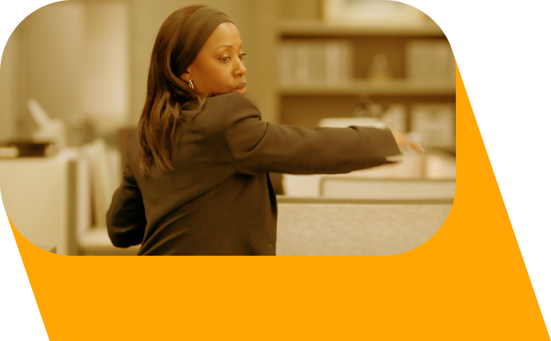 A black woman in a dark suit reaching her arm across her body