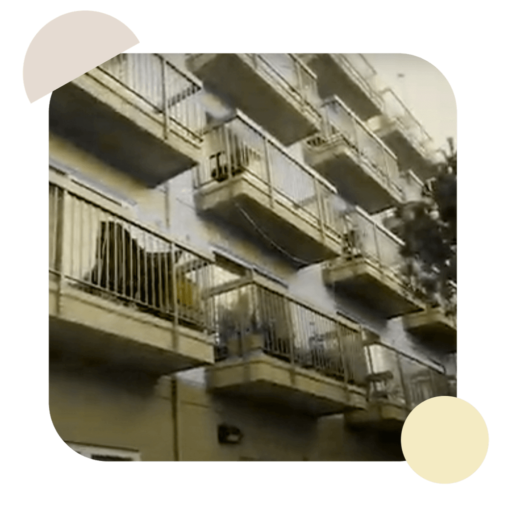 four stories of a white apartment building with many balconies