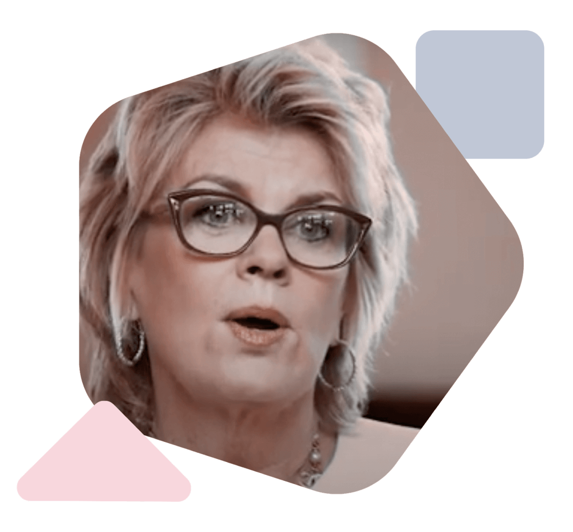 a blonde business woman with glasses speaks to the camera